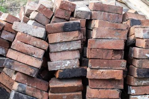 A stack of red not new fire bricks for laying a home stove Foto stock