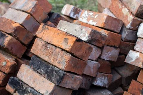 A stack of red not new fire bricks for laying a home stove Stock Photos