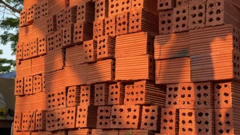 Stack of Red Perforated Clay Bricks at sunset. Construction Building Material Stock Footage 342369879