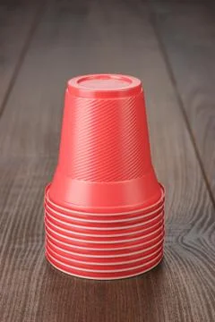 Stack of red plastic cups on the table Stock Photos