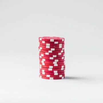Stack of red poker chips on a white background Stock Photos