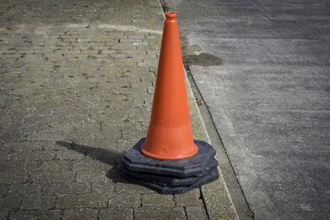 Stack of red road cones on pavement Stock Photos