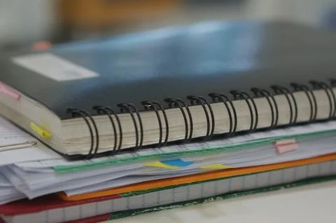 Stack of report and black notebook Foto stock