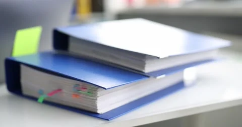 Stack of reporting paper documents in blue folder with bookmarks desktop Stock Footage 172020860