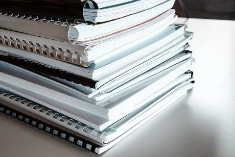 Stack of reports lies on a desk ready for review Stock Photos