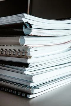 Stack of reports lies on a desk ready for review Stock Photos