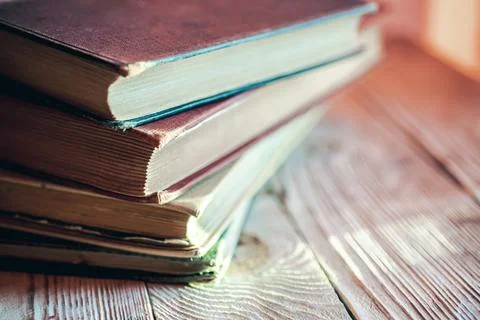 Stack of retro books on wooden table Stock Photos