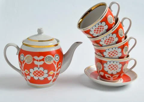 Stack of retro cups and teapot on a white background.. Stock Photos