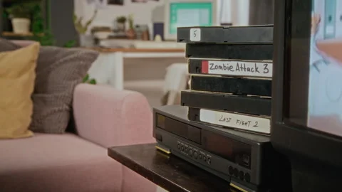Stack of Retro Vhs Tapes on Vcr Player Playing Movie on Crt Tv Stock Footage 340273218