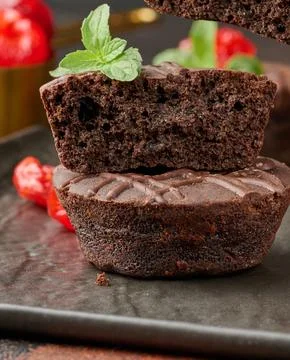 A stack of rich chocolate brownies topped with a glossy cherry and fresh mi.. Stock Illustration