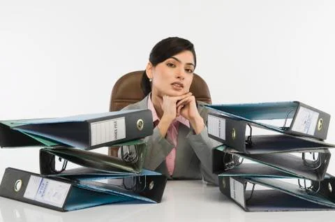 Stack of ring binders in front of a businesswoman 스톡 사진