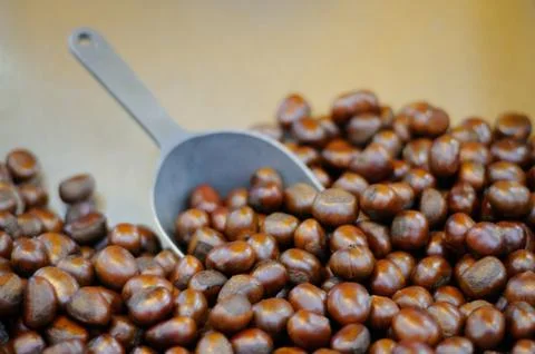 A Stack of Roasted Chestnuts with a Spoon Shovel Stock Photos