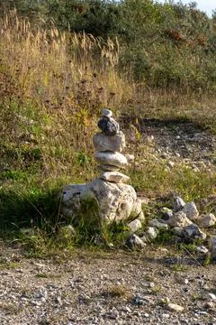 A stack of rocks is on the ground in a field Stock Photos