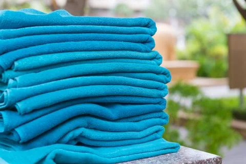 Stack roll of bath blue towels on table at swimming pool Stock Photos