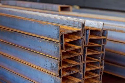 The stack of rolled metal is at the factory, overlooking the steel profile Stock Photos