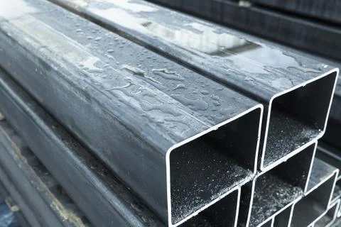 Stack of rolled metal products, wet steel pipes Stock Photos