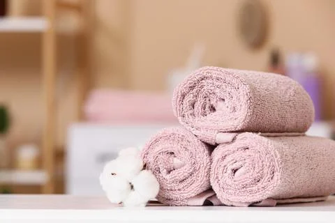 Stack of rolled pink towels with cotton flower Stock Photos
