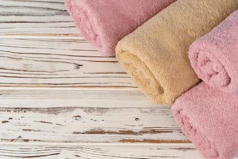Stack of rolled towels on a wooden table Stock Photos