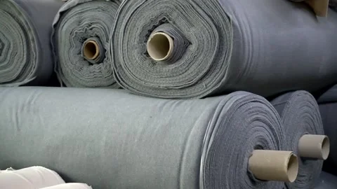 Stack of rolls of fleece fabric lies in the warehouse of a garment factory. Stock Footage 247828187