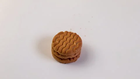 A stack of round, brown cookies stands upright against a white background. The Stock Footage 297015606