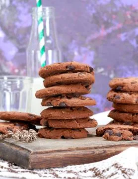 Stack of round chocolate chip cookies on a brown wooden board Stock Photos