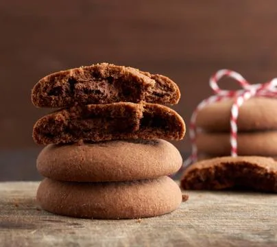 Stack of round chocolate chip cookies tied with a rope on a brown board Stock Photos