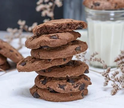 Stack of round chocolate cookies and milk Stock Photos