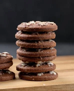 Stack of round chocolate cookies on a black background Stack of round choc... Stock-Fotos