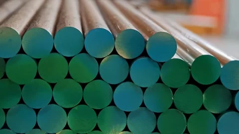 Stack of round green raw material rods in a factory warehouse. Blanks for Video stock 329320388