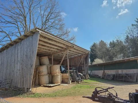 A stack of round hay bales stored inside a barn during the summer. The phot.. Stock Photos
