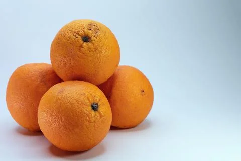 Stack Of Round Oranges With Textured Skin Isolated On White Stock-Fotos