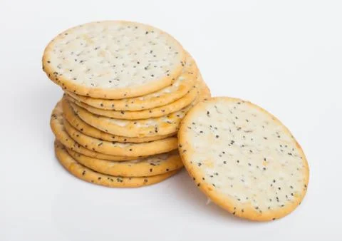 Stack of round organic crispy wheat and five grain salty crackers with seeds Stock-Fotos