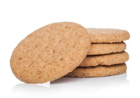 Stack of round organic crispy wheat and five grain salty crackers on white Foto stock