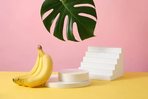 A stack of round podium decorated with a staircase, banana bunch and tropical Stock-Fotos