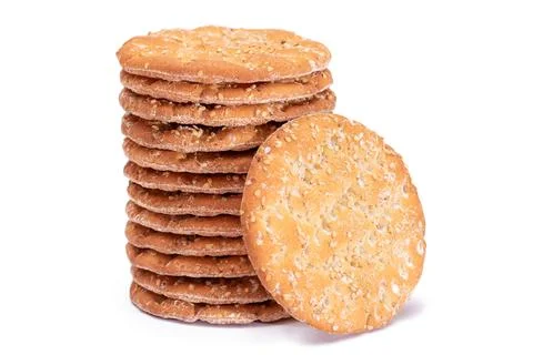 A Stack of Round Salt Crackers with Sesame Isolated on White Background Stockfoto's