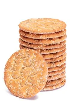 A Stack of Round Salt Crackers with Sesame Isolated on White Background Stockfoto's