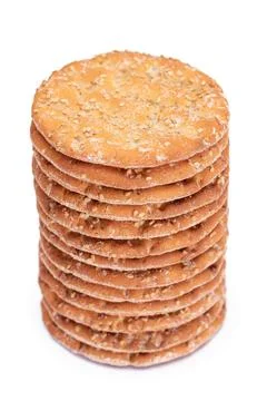 A Stack of Round Salt Crackers with Sesame Isolated on White Background Stockfoto's