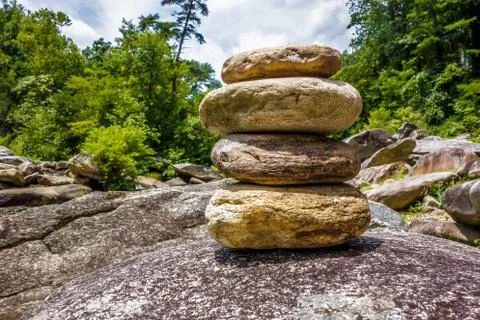 Stack of round smooth stones near mountain river Foto stock