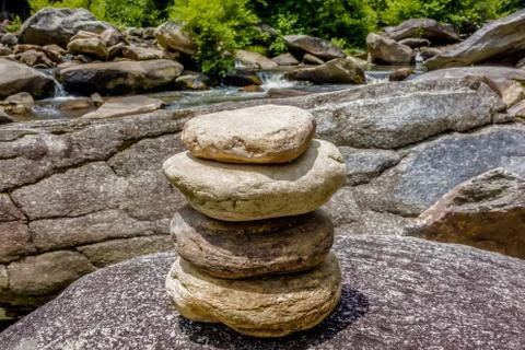 Stack of round smooth stones near mountain river Stockfoto's