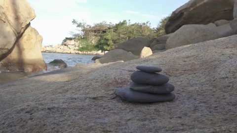 Stack of round smooth stones on a seashore Stockbeeldmateriaal 82757851