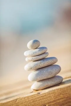 Stack of round smooth stones on a seashore Stock Photos