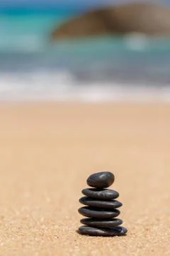 Stack of round smooth stones on a seashore Stock Photos