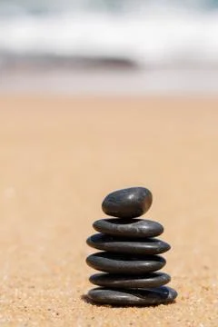 Stack of round smooth stones on a seashore Stock Photos