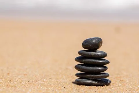 Stack of round smooth stones on a seashore Stock Photos