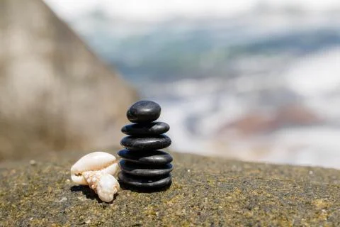 Stack of round smooth stones on a seashore Stock Photos