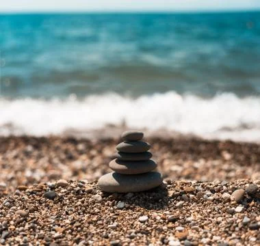 Stack of round smooth stones on a seashore Stock Photos