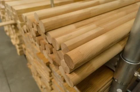 A stack of round stick in a hardware store. Wooden products for construction and Stock Photos