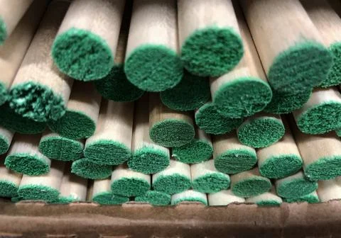 Stack of round sticks painted with green on the tips Stock-Fotos