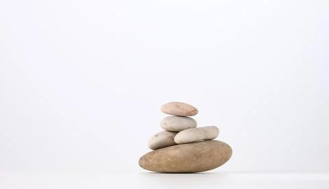 Stack of round stones on a white background. Scene for demonstration of cosme Stock-Fotos