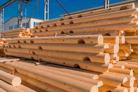 Stack of round timber logs for building wooden house. Removing bark from logs Stock Photos
